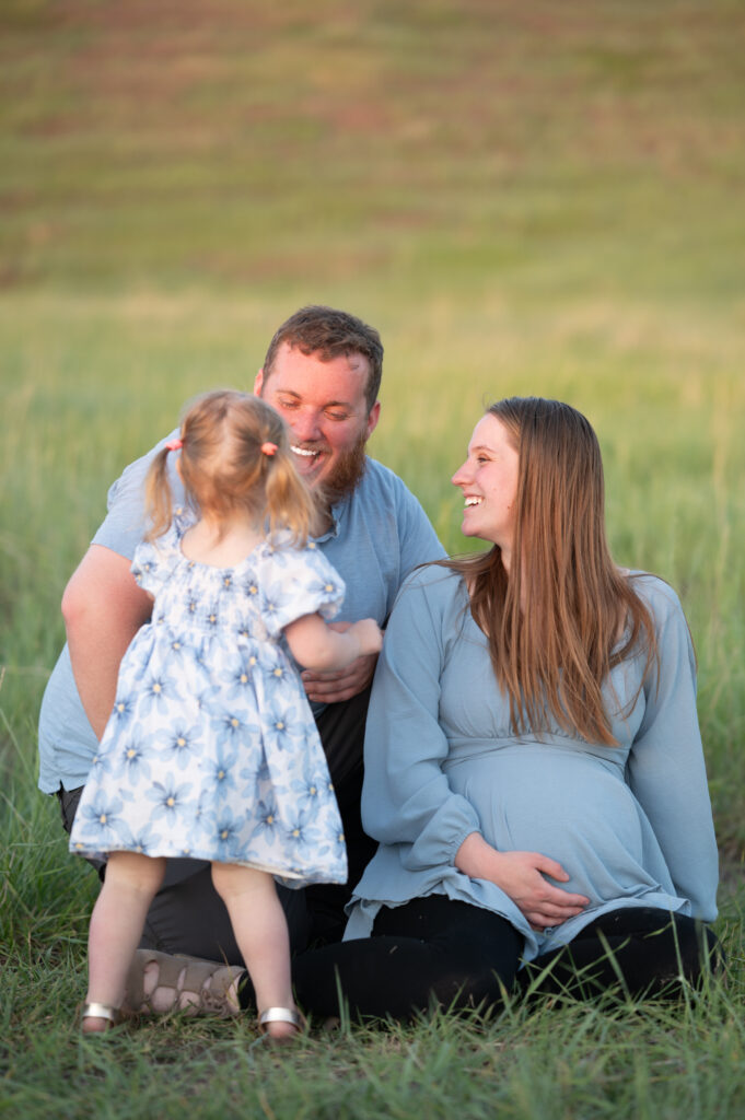 Family of three smiling and laughing at each other at Tunnel Springs for a Utah County Family Photographer