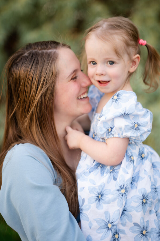 Mom and daughter smiling for the camera of a Utah County Family Photographer.