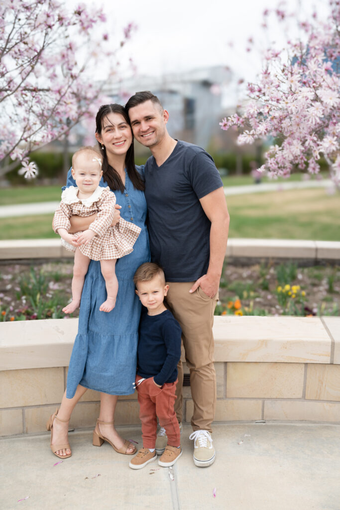 Happy family of four posing for a photographer during their Salt Lake City Family Photos